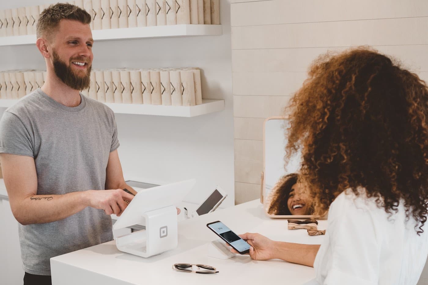 An owner ringing up a customer at the counter